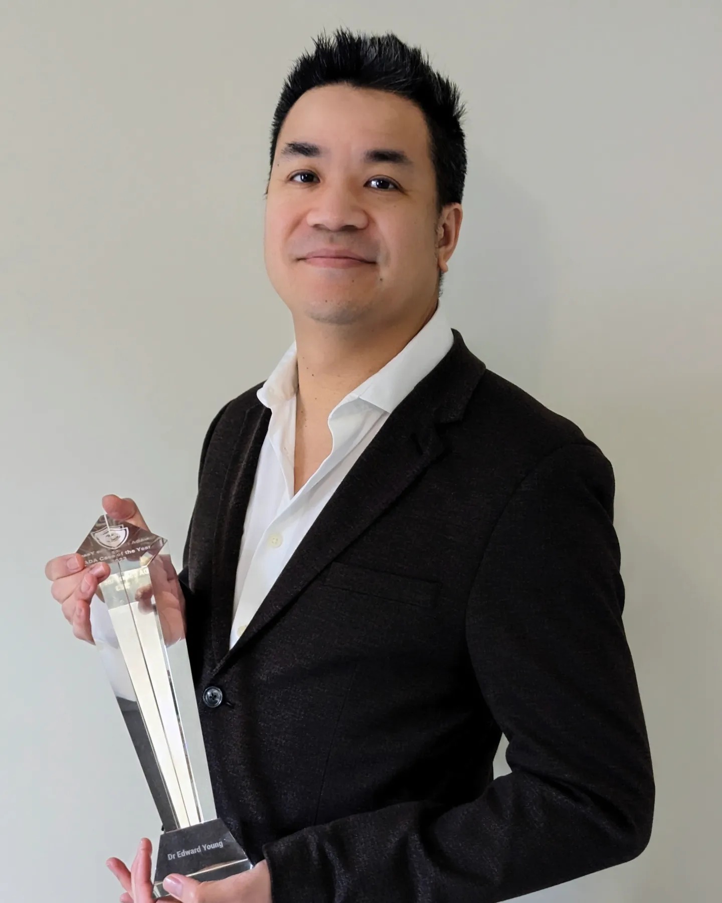Dr Ed Young holding the Aligner Case of the Year award